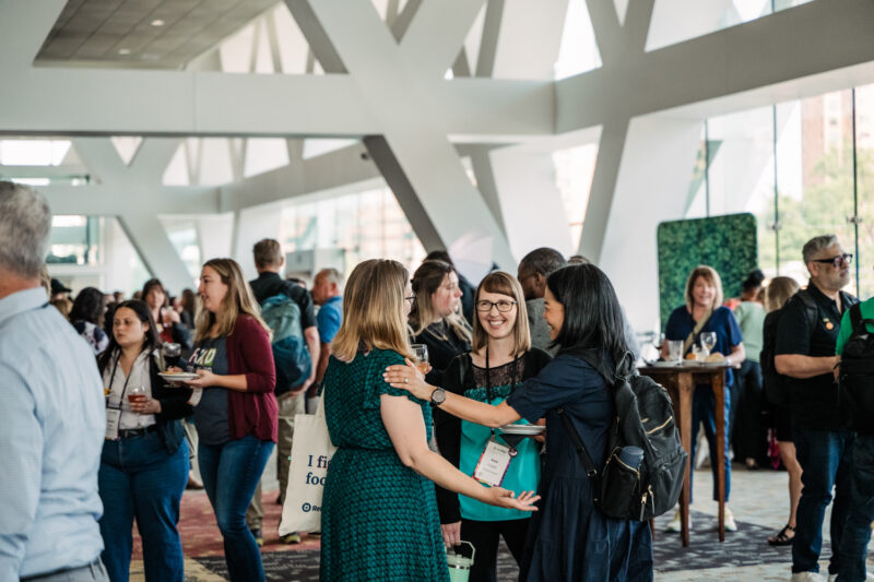 refed summit guests greeting each other between sessions