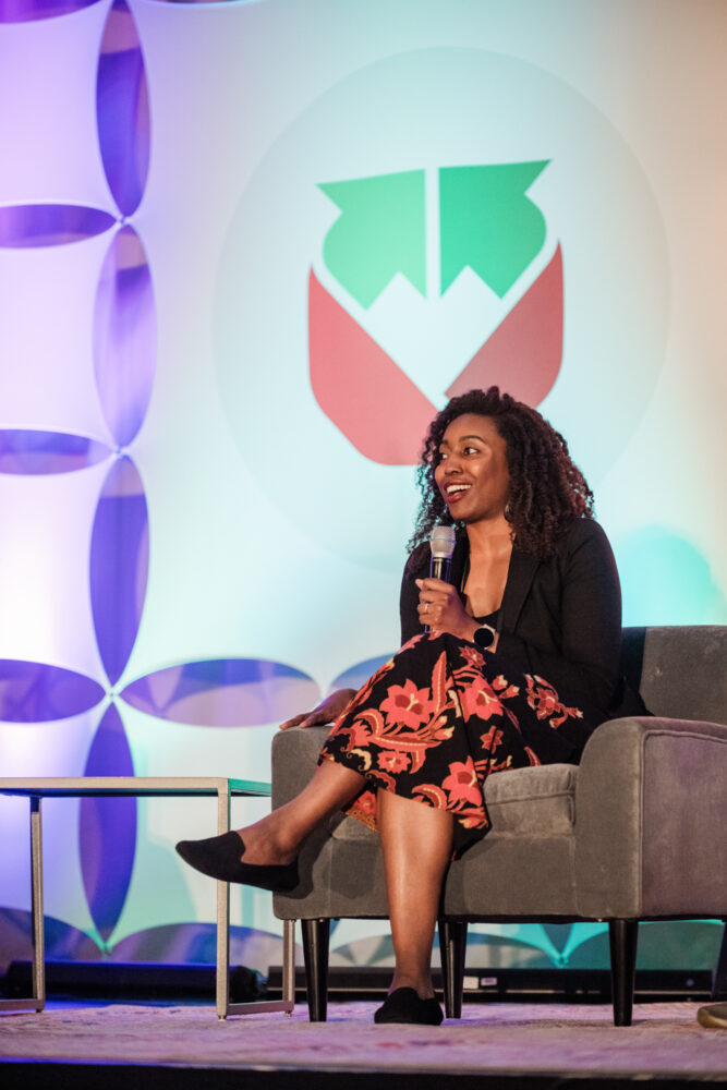 refed conference speakers on a stage for a panel