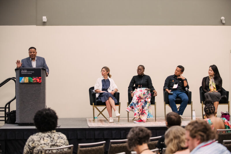 refed conference speakers on a stage for a panel