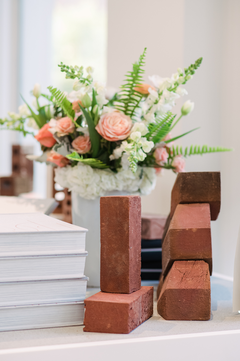 flower arrangement and bricks arranged on table