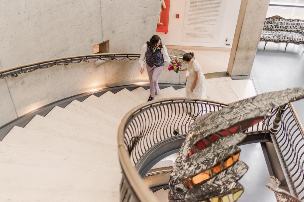 couple embracing on wedding day on staircase