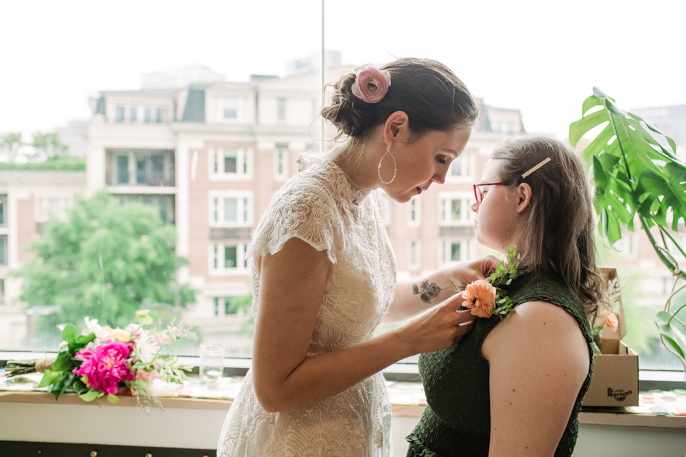 bride helping sister with flowers