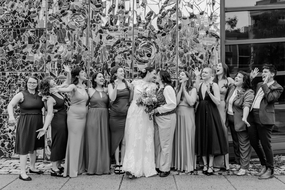 black and white photo of couple and wedding party on wedding day