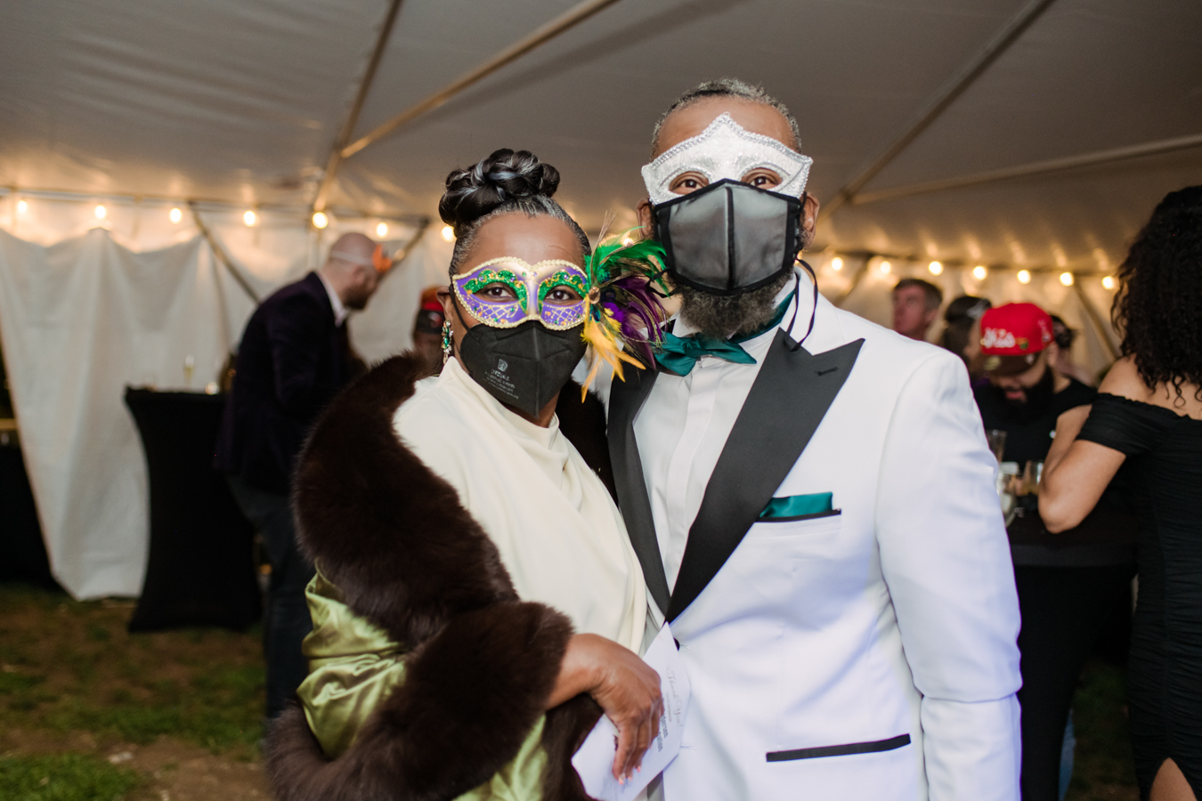 guests pose together at SFNC masquerade gala wearing masks