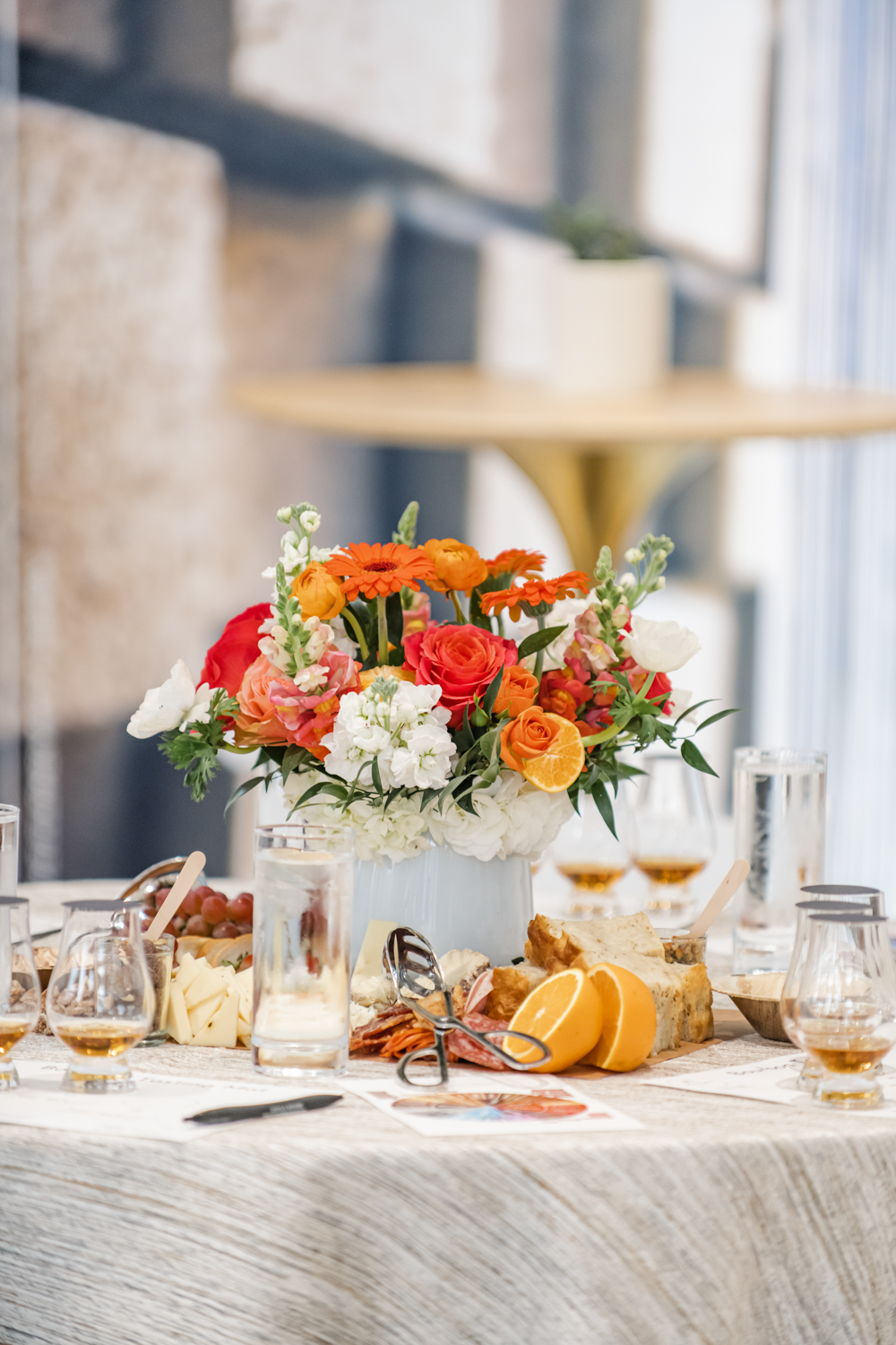 Orange flower arrangement at bourbon tasting event