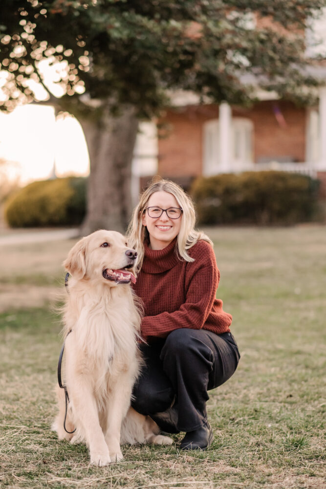 portrait of blonde woman with glasses and dog