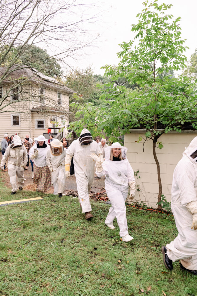 guests lined up in bee suits to see hives