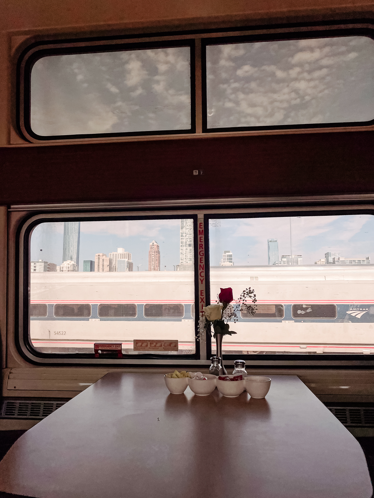 view out amtrak train car to chicago in distance