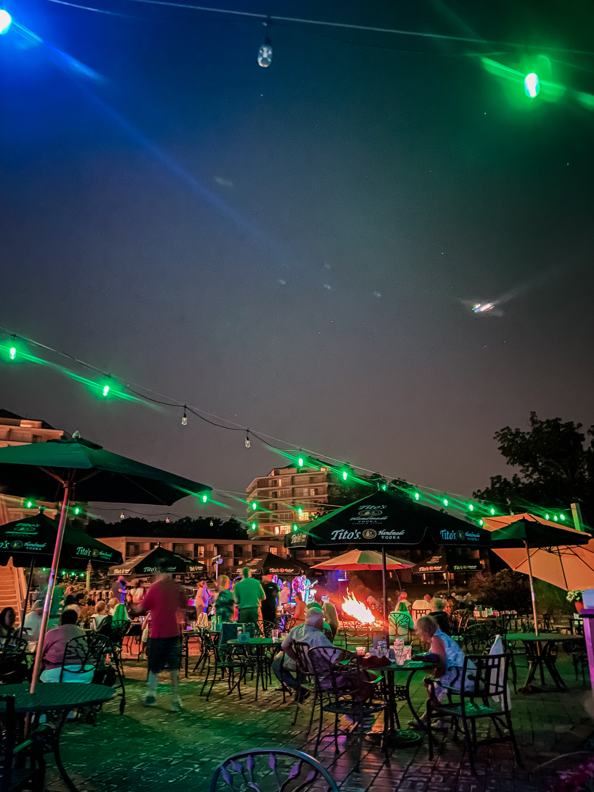 outdoor tables and people enjoying live music at a resort