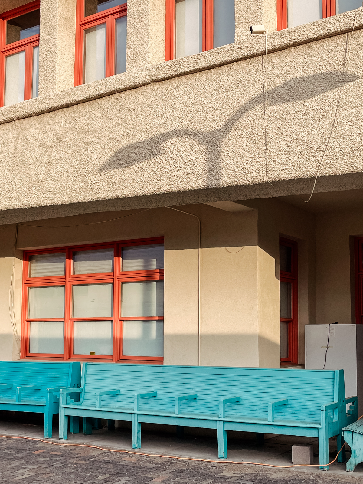 building with shadow from lightpost on the wall