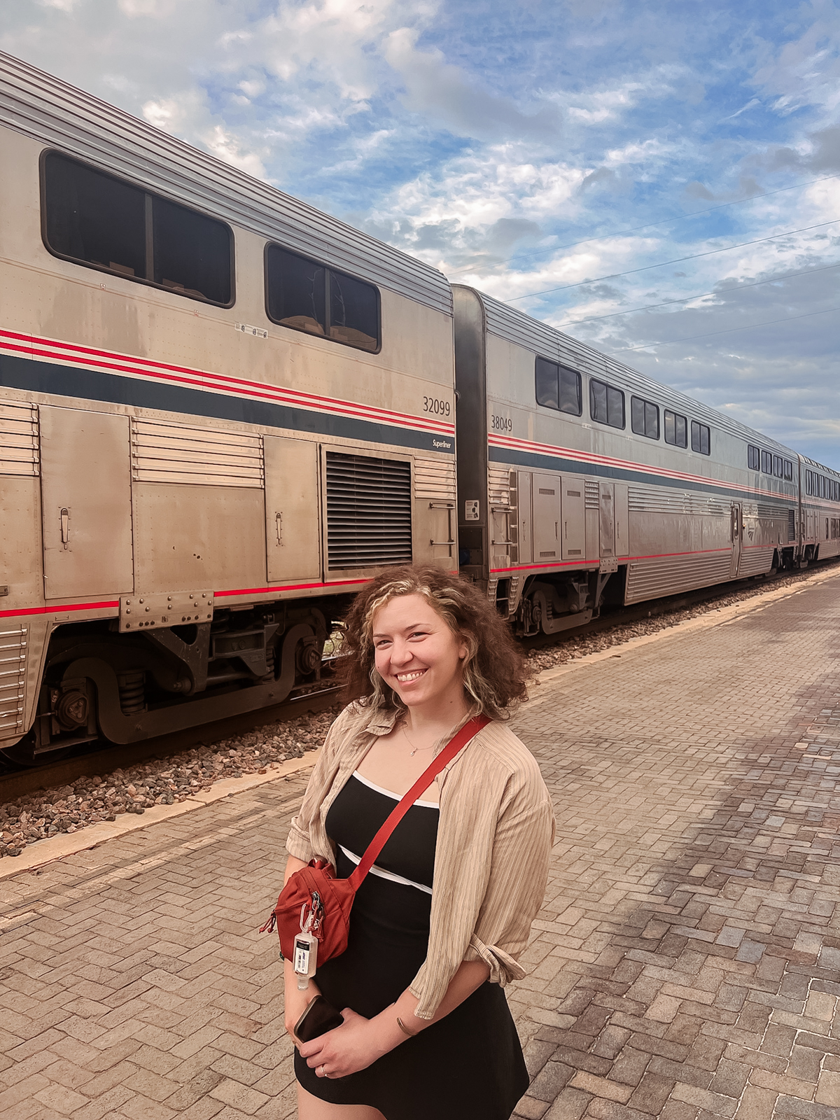 woman smiling in front of train