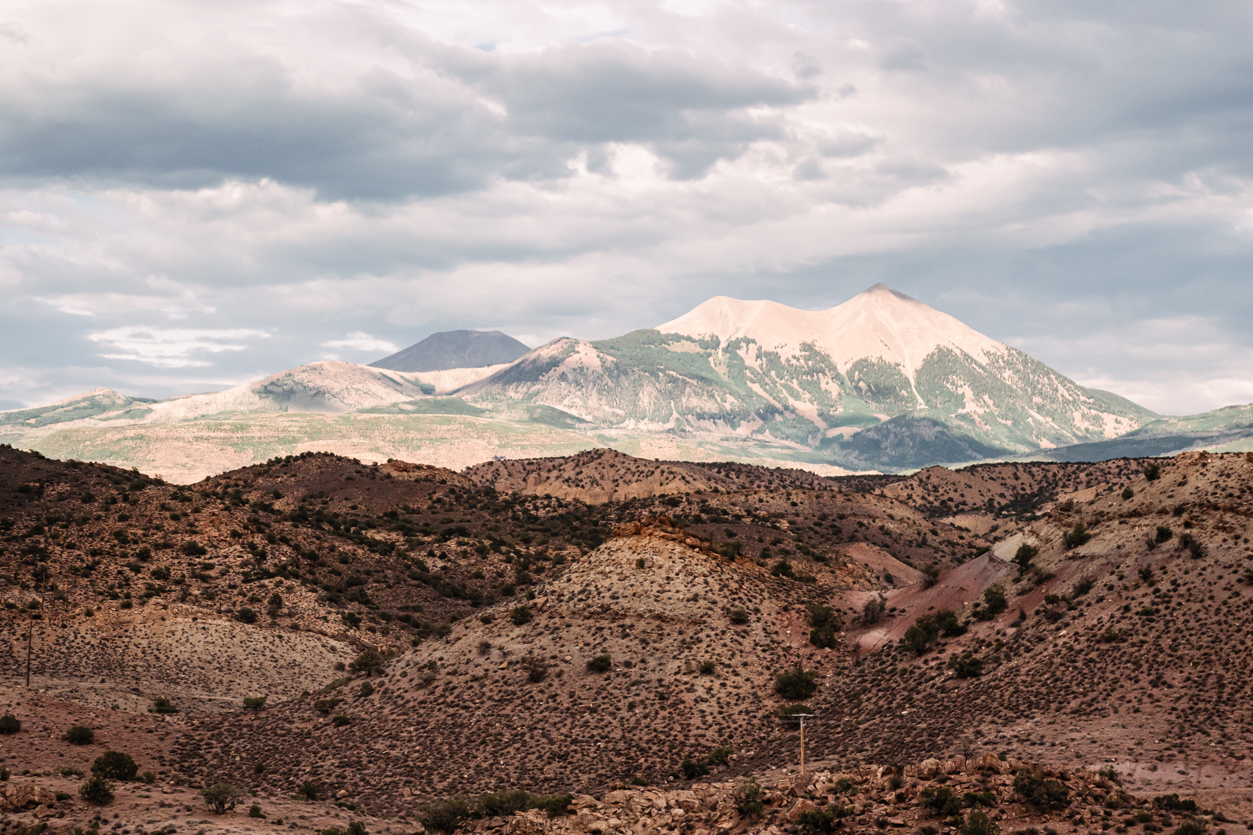 mountain with snow cap in desert in distance