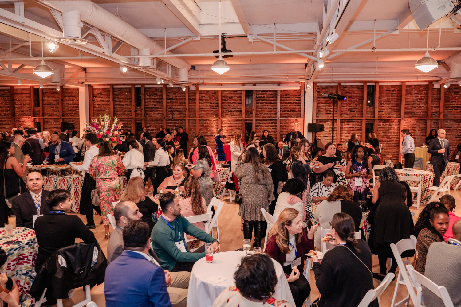 Global Refuge staff at tables in a large room at AVAM