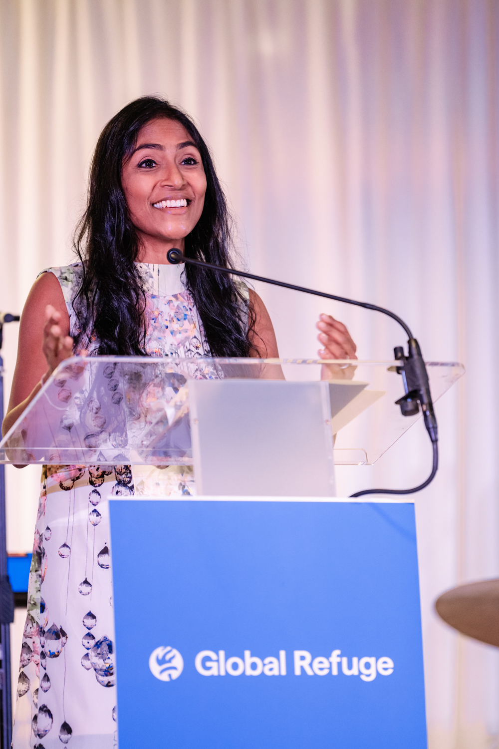 Krish O'Mara speaking at a podium