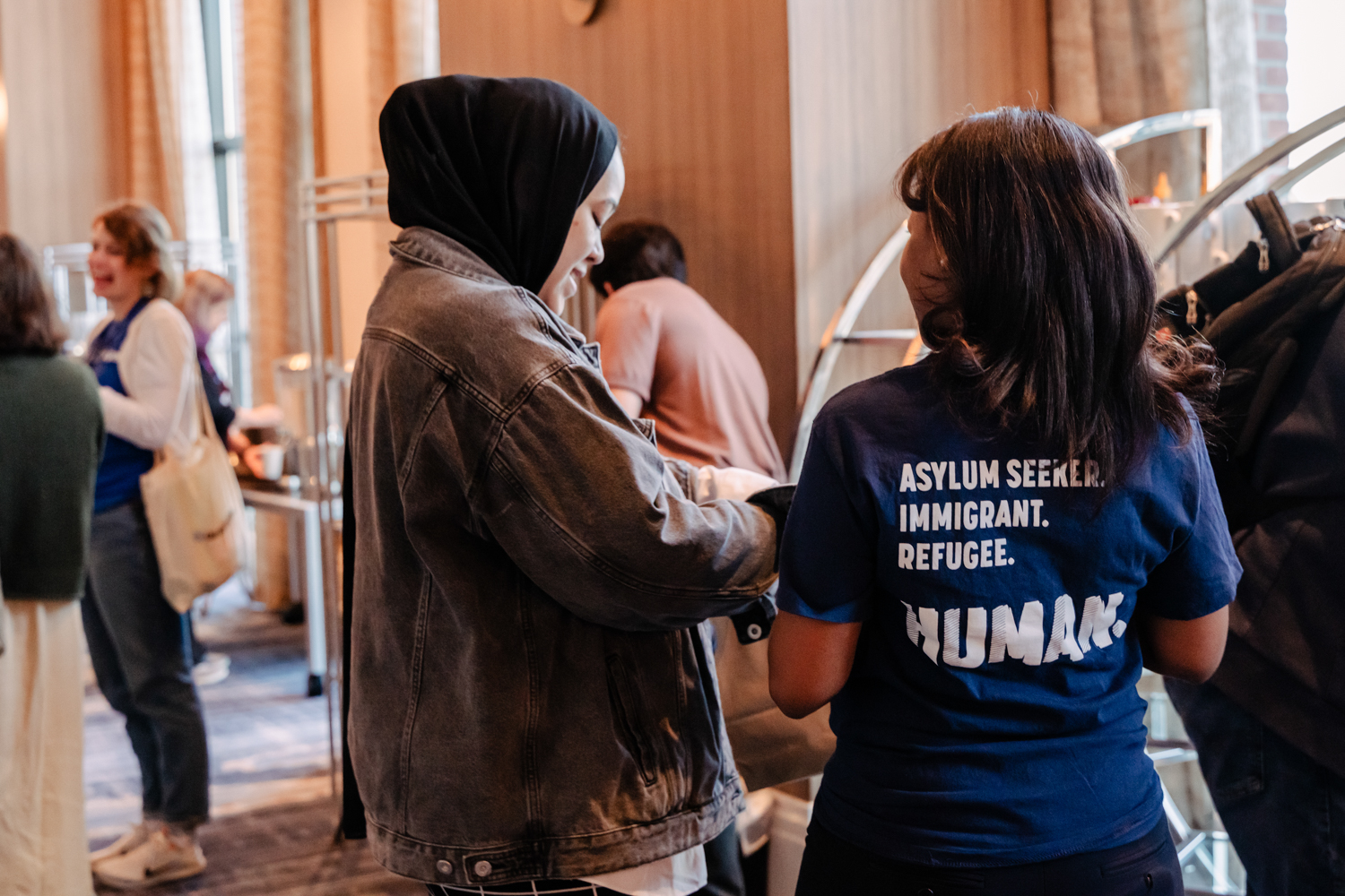 Two staff members talk to each other