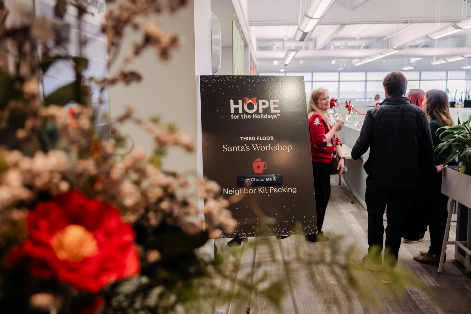 signage and guests at the event for Hope for the Holidays