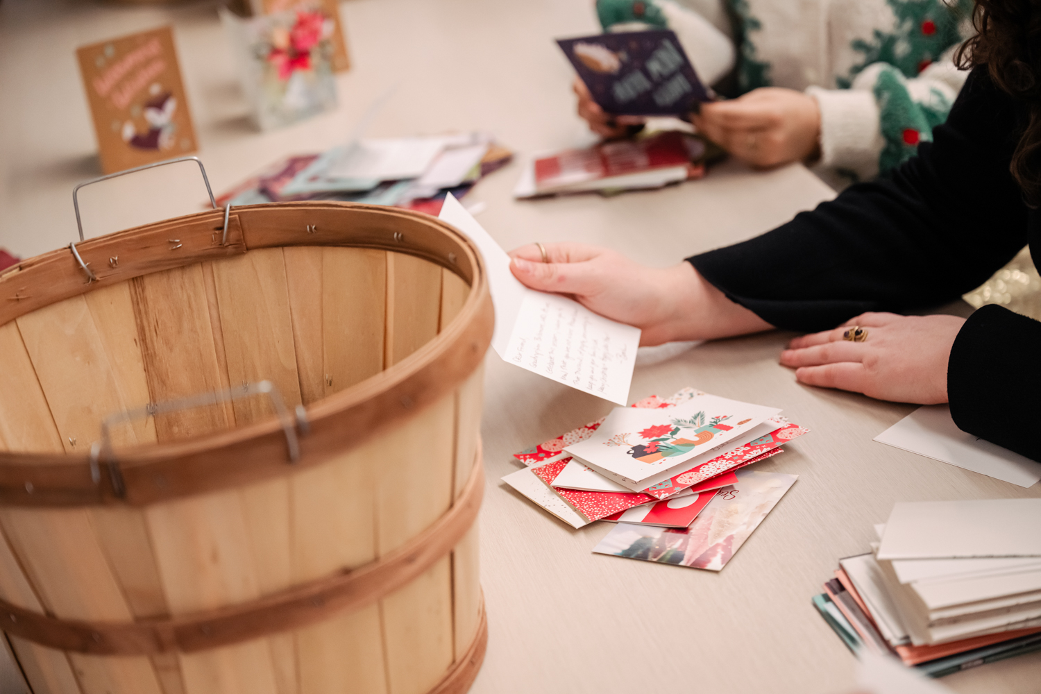 close up of a person reading one of the holiday cards