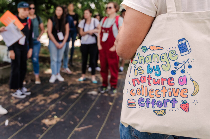 close up of bag that reads "change is by nature a collective effort"
