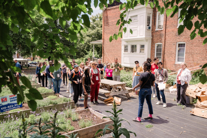 organizer speaks to group at urban farm