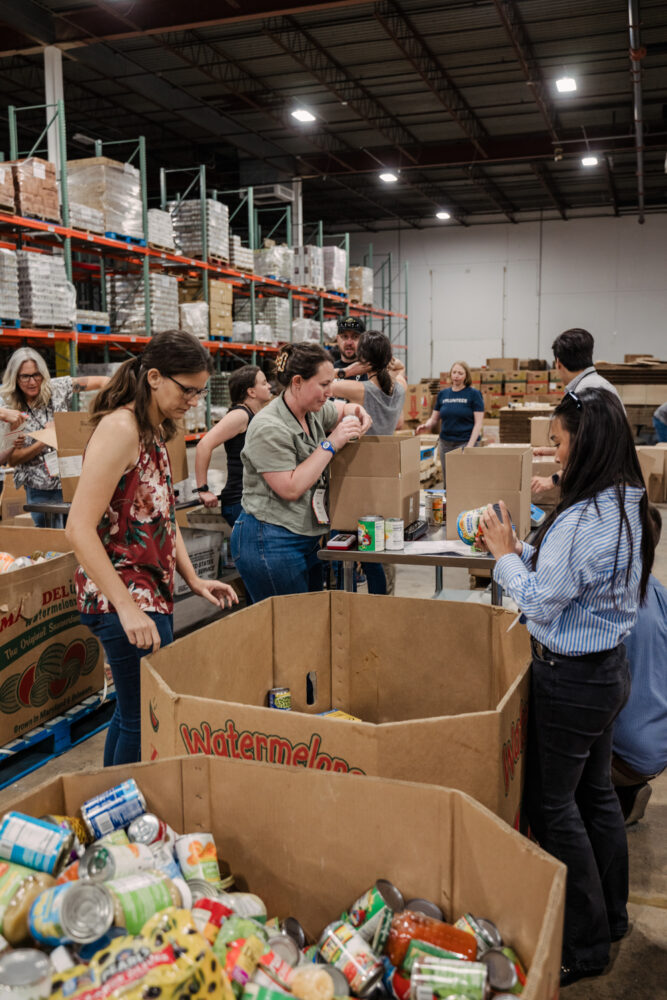 conference guests help pack goods at maryland food bank
