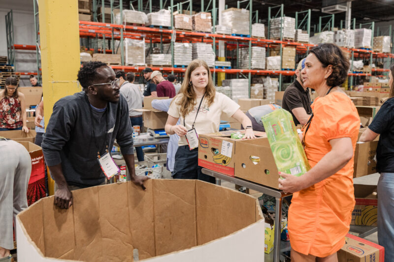 conference guests help pack goods at maryland food bank