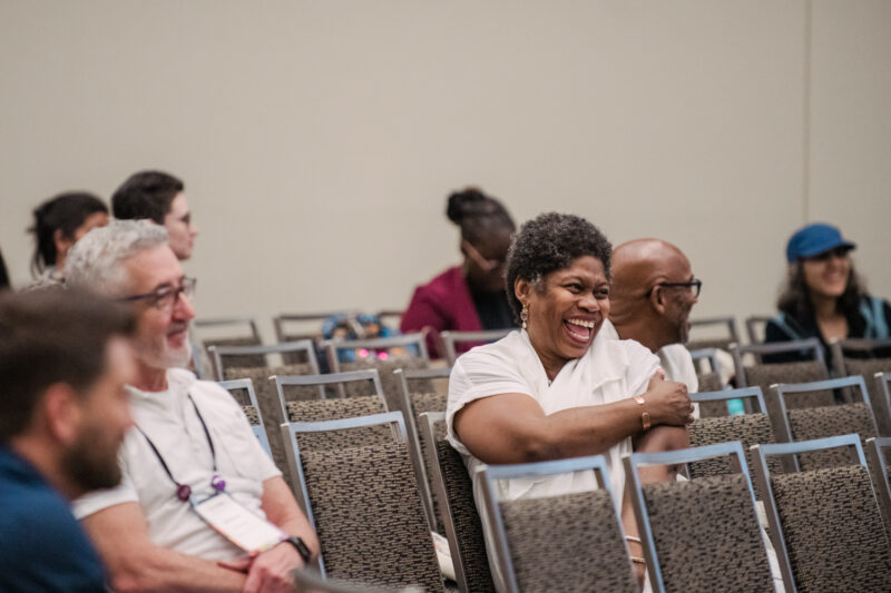 guests listening and smiling at conference
