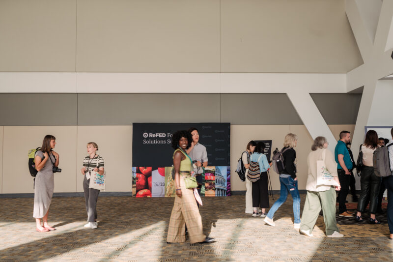 conference guests walk by hallway in conference center