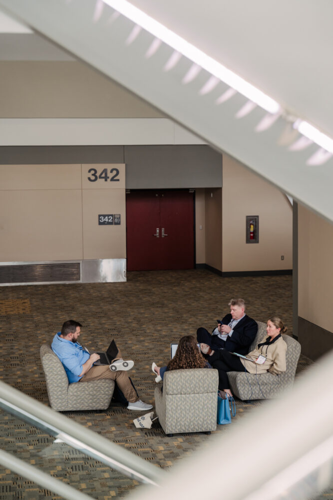 refed conference guests sitting in lounge area