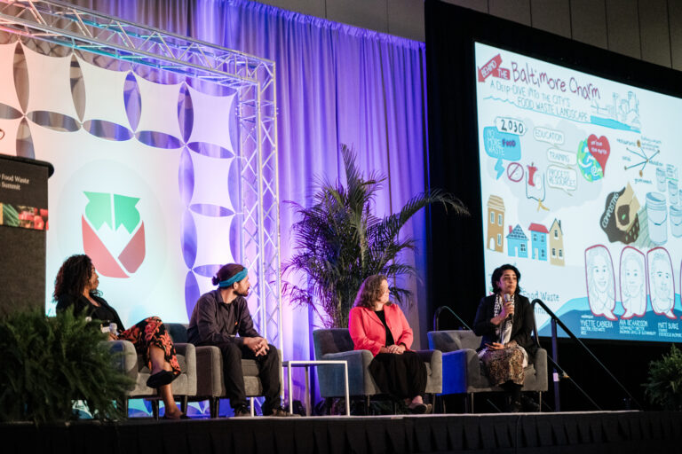 refed conference speakers on a stage for a panel