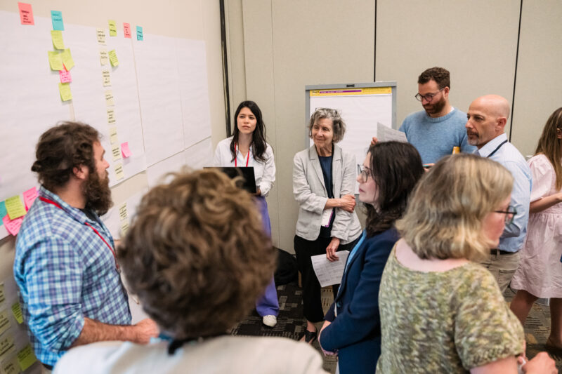 refed team brainstorming around a sticky note wall